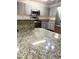 Bright kitchen features granite countertops and stainless steel appliances at 15013 Redcliff Dr, Tampa, FL 33625