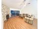 Cozy living room with a stone fireplace, high ceilings, and sliding glass doors to the outdoor patio at 15013 Redcliff Dr, Tampa, FL 33625