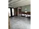 Tiled sunroom with framing and modern black-framed French doors, ready to be customized and renovated at 1751 Massachusetts Ne Ave, St Petersburg, FL 33703
