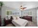 Cozy main bedroom with ample natural light, ceiling fan, and stylish decor at 2021 58Th S St, Gulfport, FL 33707