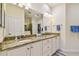 Bathroom features granite countertops, double sinks, and a walk-in closet for ample storage at 2253 Oakley Green Dr # 26, Sun City Center, FL 33573