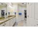Bathroom with granite countertops, double sinks, and a walk-in closet for ample storage at 2253 Oakley Green Dr # 26, Sun City Center, FL 33573