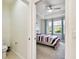 Neutral toned bathroom features a toilet in a private area and a doorway to a bright bedroom at 2253 Oakley Green Dr # 26, Sun City Center, FL 33573
