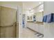 Bright bathroom featuring dual sinks, granite countertops, and a glass shower creating a spa-like retreat at 2253 Oakley Green Dr # 26, Sun City Center, FL 33573