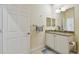 Bathroom featuring a vanity with granite countertop, mirror, and towel rack at 2253 Oakley Green Dr # 26, Sun City Center, FL 33573