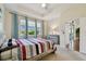 Cozy bedroom with large windows providing beautiful views and a natural light-filled space at 2253 Oakley Green Dr # 26, Sun City Center, FL 33573