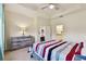 Comfortable bedroom featuring a ceiling fan, tray ceiling and an ensuite bathroom at 2253 Oakley Green Dr # 26, Sun City Center, FL 33573