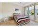 Bedroom with large windows that provide ample natural light and views of the backyard at 2253 Oakley Green Dr # 26, Sun City Center, FL 33573