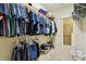 Organized walk-in closet featuring metal shelving, hanging rods, and a view into an attached bathroom at 2253 Oakley Green Dr # 26, Sun City Center, FL 33573