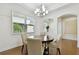 Bright dining room featuring a modern chandelier and hardwood floors, next to a quite sitting area at 2253 Oakley Green Dr # 26, Sun City Center, FL 33573