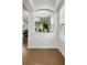 Entryway with warm hardwood floors, arched openings, and views into other rooms, offering an open layout at 2253 Oakley Green Dr # 26, Sun City Center, FL 33573