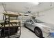 Spacious garage featuring a golf cart, a silver car, and an automatic door opener at 2253 Oakley Green Dr # 26, Sun City Center, FL 33573