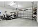 Well-lit garage featuring storage shelves, golf clubs, a grill, and a golf cart at 2253 Oakley Green Dr # 26, Sun City Center, FL 33573
