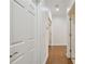 Hallway with wood floors, white walls and trim, and doors leading to different rooms at 2253 Oakley Green Dr # 26, Sun City Center, FL 33573