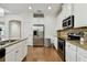 Bright kitchen featuring stainless steel appliances, granite counters, white cabinets, and a refrigerator with water dispenser at 2253 Oakley Green Dr # 26, Sun City Center, FL 33573