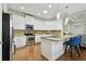 Modern kitchen featuring white cabinets, stainless steel appliances, granite countertops, and bar seating at 2253 Oakley Green Dr # 26, Sun City Center, FL 33573