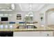 Open kitchen boasts granite countertops, stainless steel appliances, and connects to a casual eating area, filled with natural light at 2253 Oakley Green Dr # 26, Sun City Center, FL 33573