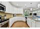 Spacious kitchen with white cabinets, granite countertops, and stainless steel appliances, blending style and functionality seamlessly at 2253 Oakley Green Dr # 26, Sun City Center, FL 33573
