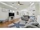 Inviting living area boasts a ceiling fan, hardwood flooring, and opens to the kitchen area at 2253 Oakley Green Dr # 26, Sun City Center, FL 33573