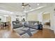 Spacious living room featuring hardwood floors, comfortable seating, and seamless transition into the dining area at 2253 Oakley Green Dr # 26, Sun City Center, FL 33573