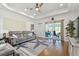 Spacious living room with tray ceiling, fan, wood floors, and sliding doors to the lanai offering a seamless indoor/outdoor living at 2253 Oakley Green Dr # 26, Sun City Center, FL 33573