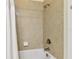 Close-up of a tiled shower-tub combination with white curtain at 2253 Oakley Green Dr # 26, Sun City Center, FL 33573