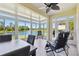 Inviting sunroom with panoramic lake views, perfect for relaxing or entertaining guests in a serene setting at 2253 Oakley Green Dr # 26, Sun City Center, FL 33573