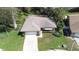Aerial view of a one-story home featuring a two-car garage and landscaping at 2457 Orangepointe Ave, Palm Harbor, FL 34683