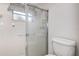 Cozy bathroom featuring a stand up shower with sliding glass door and standard toilet at 2457 Orangepointe Ave, Palm Harbor, FL 34683