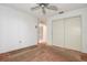 Simple bedroom with a ceiling fan, neutral walls, a closet, and carpeted floors, offering a blank canvas at 2457 Orangepointe Ave, Palm Harbor, FL 34683