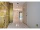 Entryway view with tile flooring leading to a large living space, with an ornate art piece on the wall at 2457 Orangepointe Ave, Palm Harbor, FL 34683