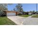A charming one-story home with a two-car garage and a neatly manicured lawn at 2457 Orangepointe Ave, Palm Harbor, FL 34683