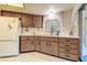 Cozy kitchen featuring wood cabinets, white countertops, and tile flooring at 2457 Orangepointe Ave, Palm Harbor, FL 34683