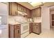 This kitchen features light-colored countertops, wood cabinets, and appliances to make meal preparation easier at 2457 Orangepointe Ave, Palm Harbor, FL 34683