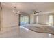Spacious living room with tile flooring, carpet, and a view of the enclosed sunroom at 2457 Orangepointe Ave, Palm Harbor, FL 34683