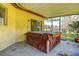 Back patio features a wooden hot tub with a brown cover and outdoor lighting at 2457 Orangepointe Ave, Palm Harbor, FL 34683