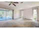 Bright sunroom with carpeted floor and natural light streaming through the many windows at 2457 Orangepointe Ave, Palm Harbor, FL 34683