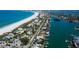 Sweeping aerial view showcasing pristine beaches, waterfront homes, and docks along the tranquil waterway at 2605 Pass A Grille Way, St Pete Beach, FL 33706