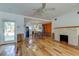 Open-concept living room with fireplace, hardwood floors, and an adjacent kitchen at 2605 Pass A Grille Way, St Pete Beach, FL 33706