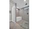 Modern bathroom with a glass-enclosed shower and a separate bathtub with gray tile surround at 2873 Doone Cir, Palm Harbor, FL 34684