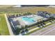 Aerial view of the community pool with lounge chairs, pergolas, and surrounding landscaping at 28740 Jujube Rd, Wesley Chapel, FL 33543