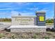 Community entrance sign for Persimmon Park at Wiregrass Ranch, with landscaping and street view at 28740 Jujube Rd, Wesley Chapel, FL 33543