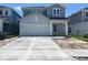 Charming two-story home featuring a two-car garage and neatly paved driveway at 28740 Jujube Rd, Wesley Chapel, FL 33543