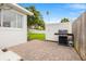 Cozy backyard patio with brick pavers, a grill, and a well-maintained fence at 292 42Nd Ave, St Pete Beach, FL 33706