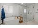 Luxurious bathroom featuring a freestanding tub, glass-enclosed shower, and sleek modern design at 292 42Nd Ave, St Pete Beach, FL 33706