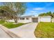 Lovely home with a long driveway, a carport, and a well-kept lawn, offering ample parking at 292 42Nd Ave, St Pete Beach, FL 33706