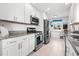 Well-lit kitchen features stainless steel appliances, granite countertops, and white cabinetry at 292 42Nd Ave, St Pete Beach, FL 33706