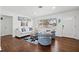 Inviting living room featuring hardwood floors, a cozy sofa, and natural light, perfect for relaxation at 292 42Nd Ave, St Pete Beach, FL 33706