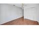 Cozy bedroom with wood-look floors, ceiling fan, and ample closet space at 3210 Mcmath Dr, Palm Harbor, FL 34684