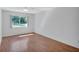 Bright bedroom with wood-look floors and a large window letting in natural light at 3210 Mcmath Dr, Palm Harbor, FL 34684